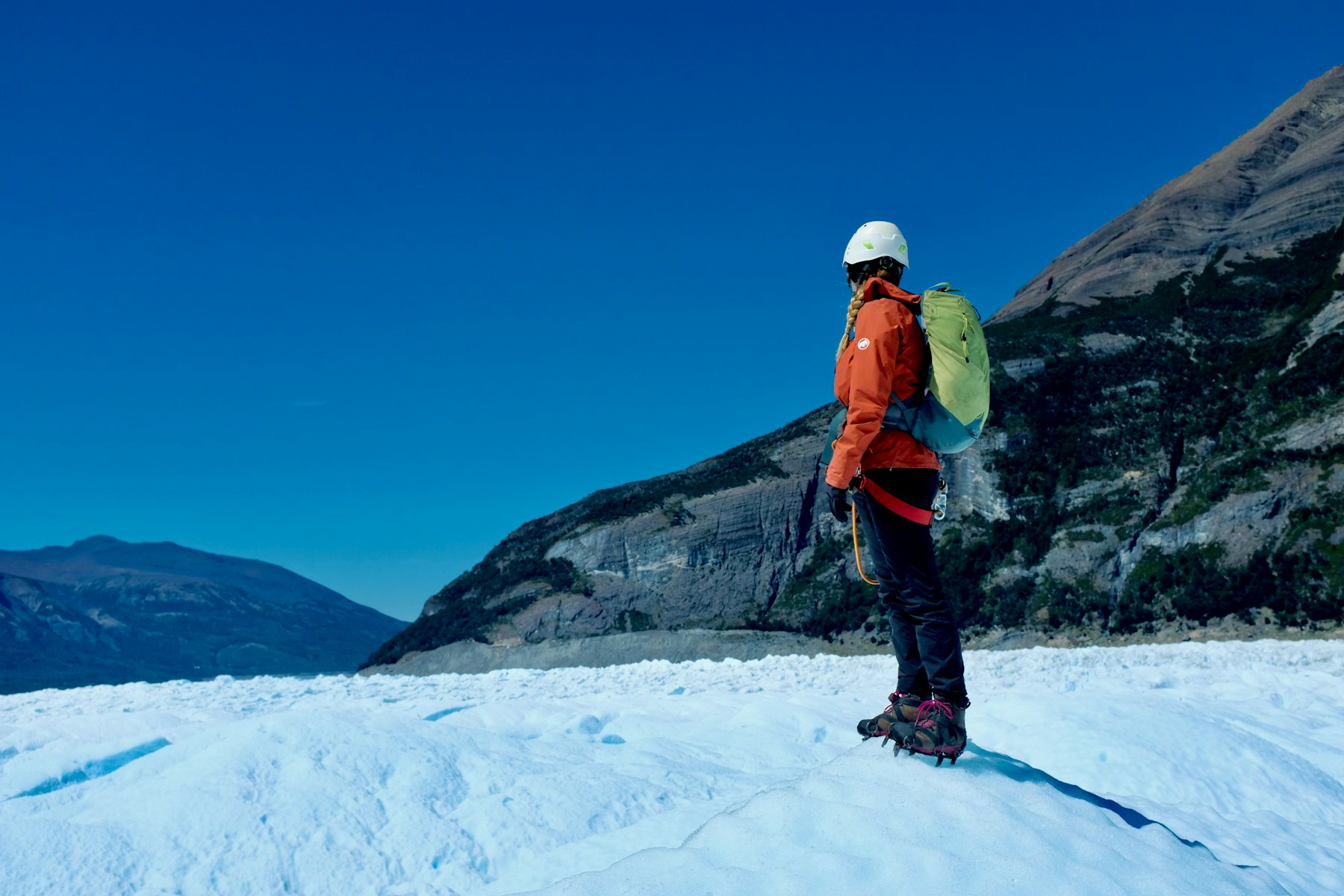 A climber crossing a glacier toward the next ridge